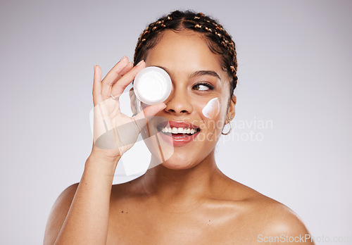 Image of Skincare, health and woman with face cream in a studio for a beauty, natural and face routine. Cosmetic, wellness and female model with facial creme, spf or moisturizer treatment by a gray background