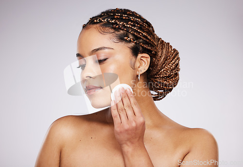 Image of Skincare, beauty or woman with cotton pad for dermatology, wellness and healthy skin on studio background. Spa aesthetic, beauty and face of girl with swab for makeup, facial treatment and cosmetics