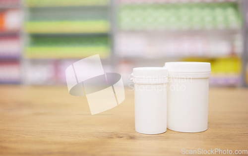 Image of Pharmacy, medicine and mockup with a tablet containers for pills on a wooden countertop for treatment. Medical, insurance and healthcare in a drugstore with mock up for pharmaceutical advertising