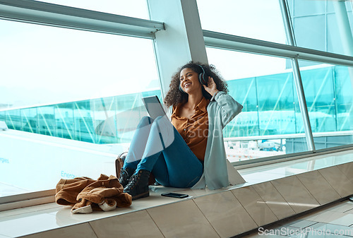 Image of Black woman, headphones and travel with tablet, airport and listening to music with business trip or holiday. Happy, flight and vacation with traveling, conference or convention with technology