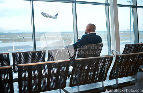 Image of Airport waiting, black man back and phone for work travel, plane and air flight. Businessman, mobile connection and person sitting with cellphone looking at traveler app info for airplane traveling