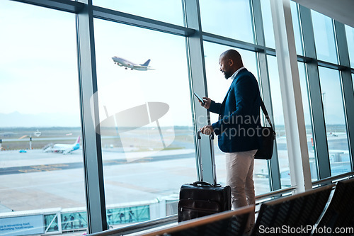 Image of Black man with phone, airport window and plane taking off, checking flight schedule terminal for business trip. Technology, travel and businessman reading international travel restrictions app online