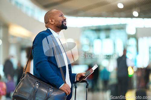 Image of Passport, flight and businessman standing in the airport checking the departure times or schedule. Travel, work trip and professional African male waiting by terminal with his ticket to board plane.