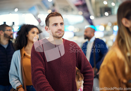 Image of Travel, queue and serious with man in airport for vacation, international trip and tourism. Holiday, luggage and customs with passenger in line for ticket, departure and flight transportation