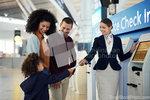 Image of Woman, passenger assistant and family at airport by self service check in station for information, help or FAQ. Happy friendly female agent helping travelers register or book airline flight ticket