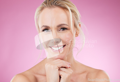 Image of Skincare, makeup and portrait of woman with smile, glowing skin and natural beauty in studio. Mockup, advertising and beauty, luxury cosmetics, face of happy blonde model isolated on pink background.