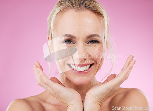 Image of Skincare, portrait of woman with smile, and hands, glowing skin with natural spa makeup in studio. Mockup, advertising and beauty, luxury cosmetics, face of happy model isolated on pink background.