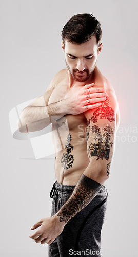 Image of Injury, feeling and a man with arm pain and muscle sprain isolated on a grey studio background. Emergency, broken bone and person touching a painful, swollen and hurt area in the body on a backdrop