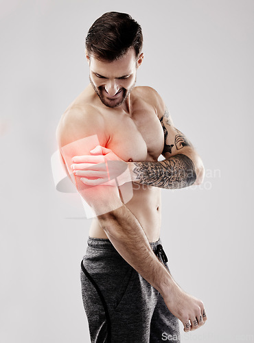Image of Sports, looking and a man with arm pain and muscle injury isolated on a grey studio background. Emergency, broken bone and person touching a painful, inflamed and hurt area in the body on a backdrop