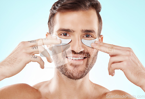 Image of Eye patch beauty, man and treatment portrait with smile and product for eyes in isolated studio. Skincare, spa wellness and facial for model face with cosmetics, dermatology and detox with collagen