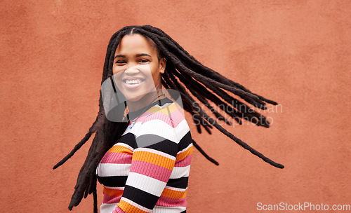 Image of Playful, fun and portrait of a black woman with a smile isolated on a studio background. Happy, laughing and a funny young African girl with dreadlocks, happiness and expression on a backdrop