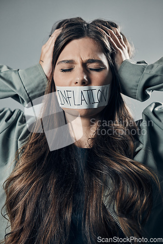 Image of Woman, tape and mouth with quiet protest, social activism and global economy crisis by background. Inflation, gen z girl and studio backdrop with economic opinion, stress and financial freedom vision