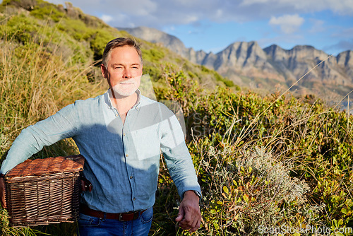 Image of Picnic, summer and a man in the mountain, walking outdoor in nature for adventure, freedom or recreation. Spring, travel and environment with a male taking a walk in the wilderness alone for hiking