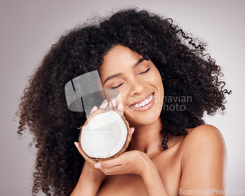 Image of Beauty, coconut and black woman isolated on studio background for natural skincare, face and hair dream. Afro model or young person sleeping with fruit product or healthy oil benefits for dermatology