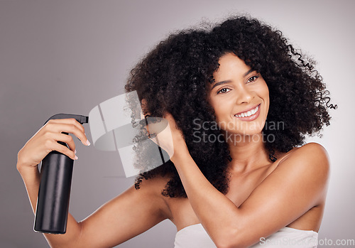 Image of Face of black woman spray product on hair for natural wellness, growth and shine on gray background. Beauty, luxury salon and happy girl smile with hairspray, cosmetic products and keratin treatment