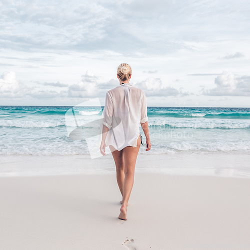 Image of Woman on summer vacations at tropical beach of Mahe Island, Seychelles.