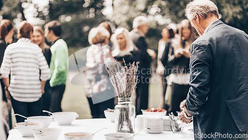 Image of Banquet lunch break at conference meeting on hotel terrace.