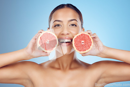 Image of Grapefruit, woman and smile for beauty portrait on studio background for wellness benefits. Skincare model, diet and citrus fruits for natural detox, healthy nutrition and happy face with vitamin c