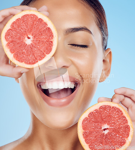 Image of Grapefruit, laughing and woman with face for beauty on studio background, wellness benefits and smile. Happy model, diet and citrus fruits for natural detox, healthy skincare and vitamin c aesthetic