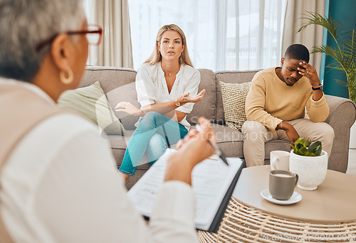 Image of Interracial couple, counseling and therapist with argument and fight on therapy sofa. Tired, relationship stress and marriage problem of people on couch feeling anxiety from divorce conversation