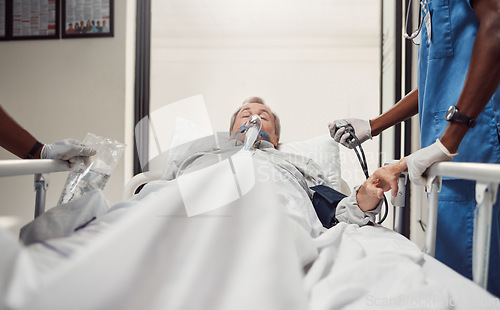 Image of Hospital, senior patient and doctors for emergency on a bed with oxygen mask for healthcare. Sick old man with health problem and medical team er or surgery in theater for life insurance and help