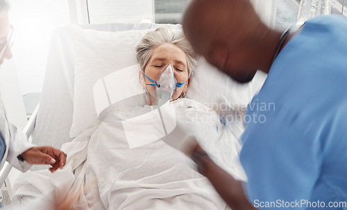 Image of Senior woman, oxygen mask and emergency in hospital bed, healthcare and doctors helping lady. Medical professionals, female patient and senior citizen with disease, illness and teamwork to assist