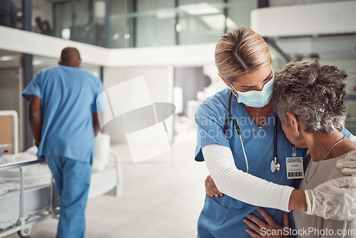 Image of Doctor, hug and sad elderly woman in hospital for support, comfort and empathy for surgery of husband. Nurse, face mask and embrace wife of patient with covid 19 emergency in clinic with solidarity