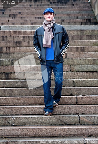 Image of Handsome man walking stairs