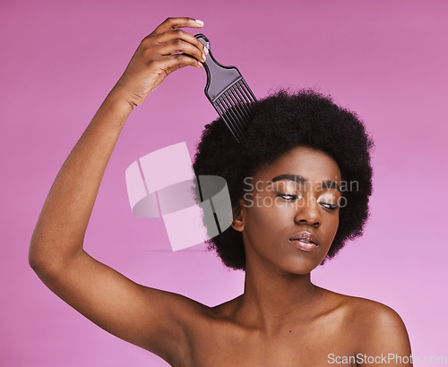 Image of Black woman, hairstyle or afro brushing on beauty studio background in relax grooming routine, texture maintenance or wellness. Model, comb or natural hair growth and skincare makeup on isolated pink