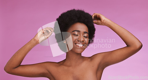 Image of Black woman touching afro hairstyle on beauty studio background in relax skincare, texture maintenance or salon wellness. Model, natural and hair growth, hands on isolated pink or makeup backdrop.