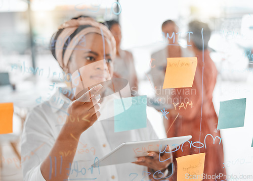 Image of Planning, thinking or black woman for brainstorming on tablet with sticky notes, planning or creative idea on glass wall. Focus, teamwork or business meeting with writing, reading or work schedule