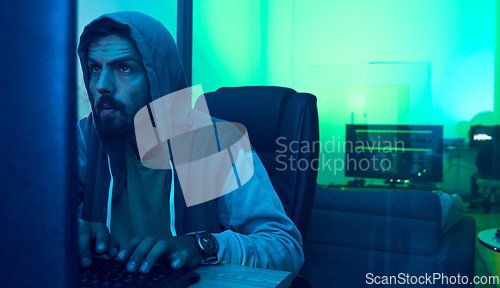 Image of Computer hacker, software and neon man hacking online database, website server or password phishing. Ransomware developer, cyber security programming and blue programmer coding malware code at night