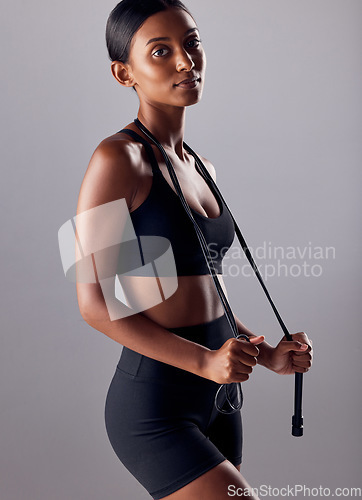 Image of Fitness, jump rope and health with portrait of Indian woman for skipping, workout and cardio training. Strong, wellness and exercise with face of girl athlete for sports, motivation and gym goals