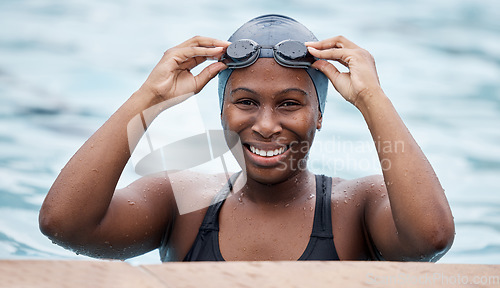 Image of Training, portrait or happy black woman in swimming pool or water for practice, workout or body fitness. Wellness, smile or healthy girl swimmer in goggles exercising for cardio endurance or exercise