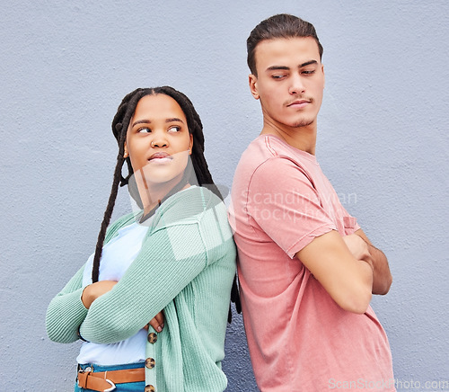 Image of Disagreement, mad and angry with interracial couple and wall background for fight, problem and argument. Ignore, upset and conflict with man and black woman for difficult, disappointed and breakup