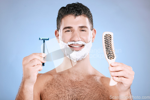 Image of Portrait, man and brush with razor, cream and mockup with guy, hygiene and grooming on blue studio background. Face, male or gentleman with skincare, cosmetic equipment or hair removal for confidence