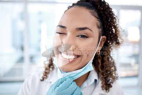 Image of Wink, covid and portrait of doctor happy and excited with a positive mindset in the hospital after coronavirus ending. Face, medical and healthcare professional or worker smile and confident