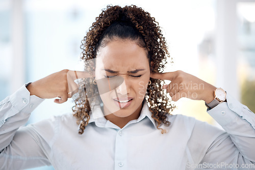 Image of Noise, loud and woman closing her ears for the sounds in the office while working on a project. Annoyed, frustrated and upset professional female employee plug her fingers in her ear in the workplace