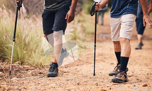 Image of Hiking, fitness and feet of people walking on mountain for adventure, freedom and journey in nature. Travel, retirement and shoes of hikers with walk cane for exercise wellness, trekking and workout