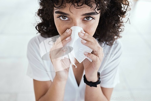 Image of Black woman, tissue and blowing nose in home for portrait with allergies, sneeze and blurred background. Gen z girl, toilet paper and sick with allergy, covid and closeup in house, apartment or room