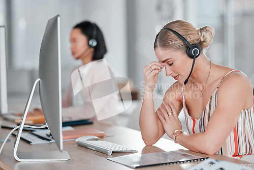 Image of Headache, stress and burnout woman in call center feeling pain, tired or exhausted. Customer service, mental health and female sales agent with depression, anxiety or migraine in office workplace.