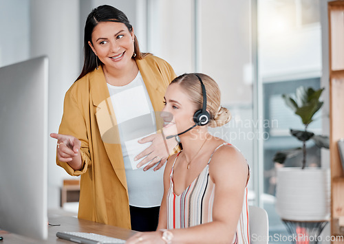 Image of Call center, coaching and pointing at computer in office with pregnant woman, smile and learning at desk. Women, happy manager and desktop with tech support, customer service and workplace education
