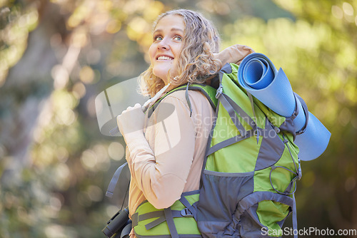 Image of Hiking, travel and woman in nature with freedom, fitness and adventure in a jungle. Smile, happiness and free female with trekking backpack for camping and walking in nature on traveler vacation