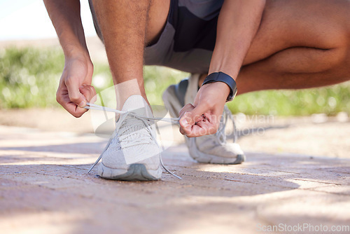 Image of Fitness, running and man tie shoes ready to start exercise, marathon training and endurance workout. Sports, nature trail and feet of male runner tying shoelace for wellness, health and performance