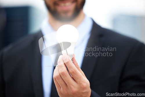 Image of Businessman, hands and light bulb with idea in the city for solution, eco friendly or renewable energy. Hand of male employee holding lamp for creativity, ideas or power saving element on mockup