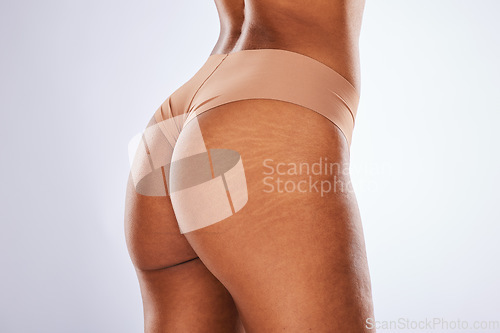 Image of Underwear, butt and black woman isolated on a white background for beauty empowerment, aesthetic or cellulite. Lingerie, body and skincare of a model with ass stretch marks or dermatology in studio