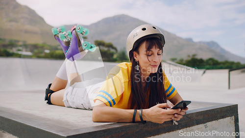 Image of Social media, chat and woman on a phone while rollerskating for communication and connection in park. Digital, internet and girl reading a message on a mobile app while at a park to skate for sports