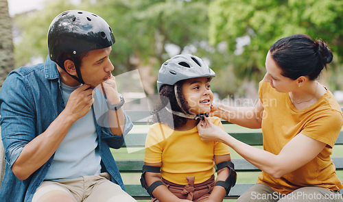 Image of Parents, park bench and helmet with child, helping hand and safety for skating, rollerskate or bike. Interracial parents, mom and dad with help, teaching and kid for bonding, learning and exercise