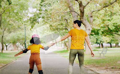 Image of Mother, child and skating with roller skates at nature park for exercise, balance and freedom. Woman and black girl kid or family outdoor to play with helmet for safety, trust and love in summer