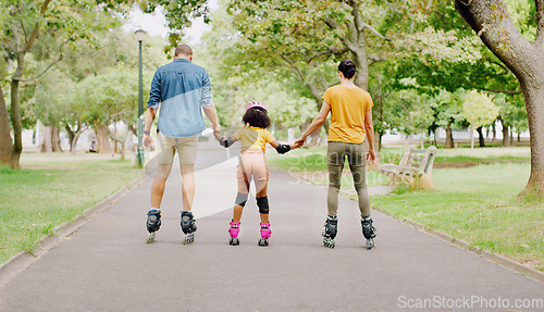 Image of Family, park and holding hands to rollerskate with girl child with care, learning and support. Interracial parents, black man and woman with kid, back and helping hand on road for outdoor holiday